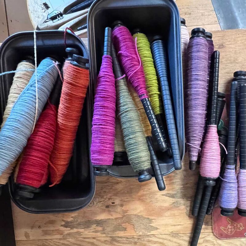 yarn bobbins in trays