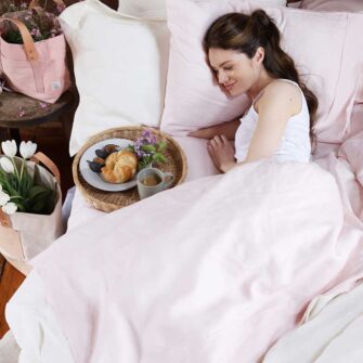 Swans Island Company's Relaxed Linen Bedding. Elegant French linen stitched in the USA for those seeking a refined and timeless sleep experience. Shown here in Blush.