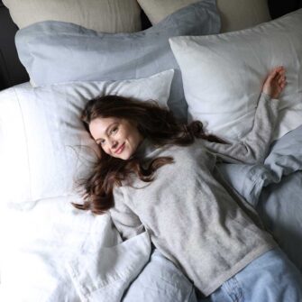 Swans Island Company's Relaxed Linen Bedding. Elegant French linen stitched in the USA for those seeking a refined and timeless sleep experience. Shown here in Sea Spray Duvet cover and shams, paired with with Classic White Sheets.