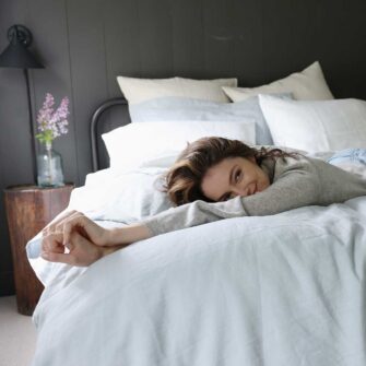 Swans Island Company's Relaxed Linen Bedding. Elegant French linen stitched in the USA for those seeking a refined and timeless sleep experience. Shown here in Sea Spray Duvet cover and shams, paired with with Classic White Sheets.