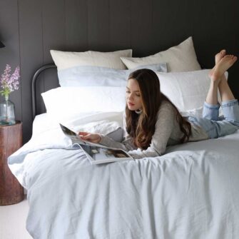 Swans Island Company's Relaxed Linen Bedding. Elegant French linen stitched in the USA for those seeking a refined and timeless sleep experience. Shown here in Sea Spray Duvet cover and shams, paired with with Classic White Sheets.