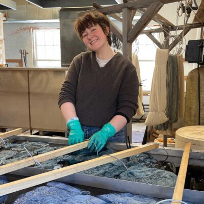 woman dying wool yarn
