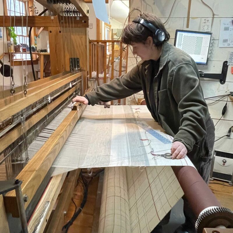 weaver working on loom