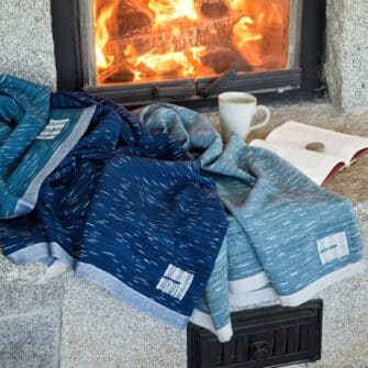 Swans Island Company Firefly Throw in Blue Spruce, Sapphire blue and Teal. 100% soft merino wool, handwoven in Maine.