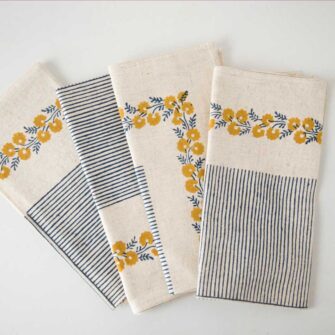 Swans Island Company's Meehak Napkins by Soil to Studio. Block printed by hand in India with bright playful patterns. Shown here in Natural with daffodil yellow and blue. Set of 4.