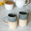 Swans Island Company's Tall Dipped Mugs are handcrafted with stoneware pottery dipped with a food-safe earthy glaze on top. Made in Maine. Shown here in Sage, set of two.