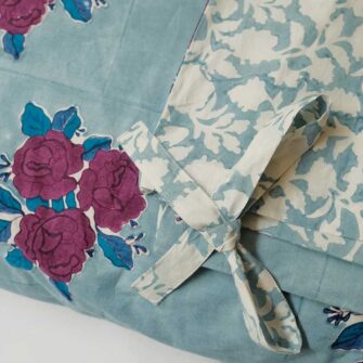 Swans Island Company's Sara Duvet Cover by Soil to Studio. Block printed by hand in India with bright playful patterns. Shown here in Denim with roses.