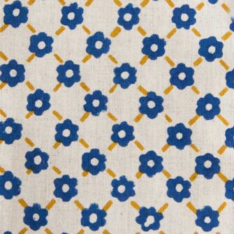 Swans Island Company's Pia Napkins by Soil to Studio. Block printed by hand in India with bright playful patterns. Shown here in Natural with yellow and blue. Swatch