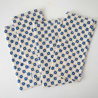 Swans Island Company's Pia Napkins by Soil to Studio. Block printed by hand in India with bright playful patterns. Shown here in Natural with yellow and blue. Set of four.