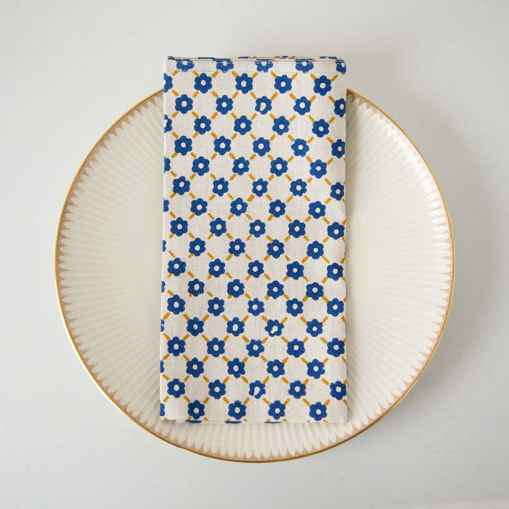 Swans Island Company's Pia Napkins by Soil to Studio. Block printed by hand in India with bright playful patterns. Shown here in Natural with yellow and blue.
