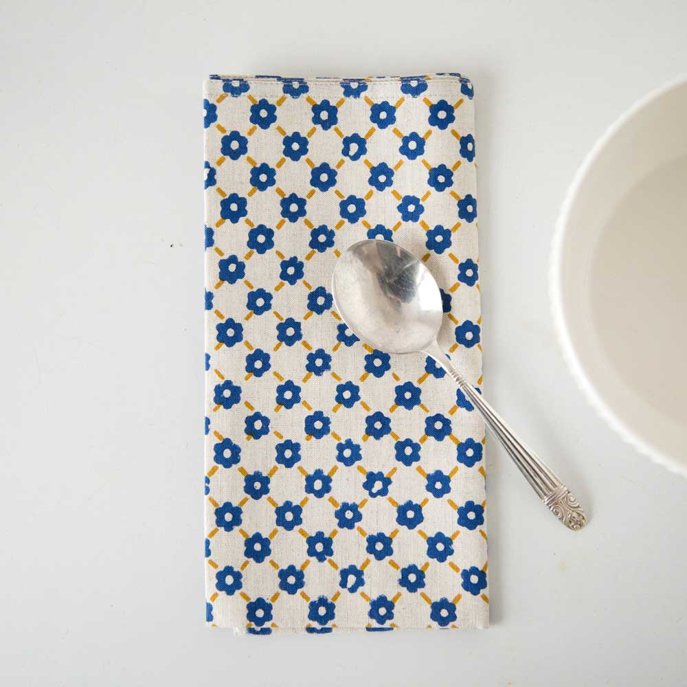 Swans Island Company's Pia Napkins by Soil to Studio. Block printed by hand in India with bright playful patterns. Shown here in Natural with yellow and blue.