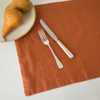 Swans Island Company's linen plaemats by Linen Tales, made with 100% European Linen Oeko-Tex® and EUROPEN FLAX® certified. Made with stonewashed soft linen with mitered corners for a crisp edge. Shown here in Baked Clay color.