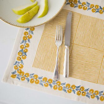 Swans Island Company's Shika Placemat by Soil to Studio. Block printed by hand in India with bright playful patterns. Shown here in Natural with daffodil yellow.