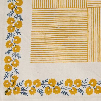 Swans Island Company's Shika Placemat by Soil to Studio. Block printed by hand in India with bright playful patterns. Shown here in Natural with daffodil yellow.