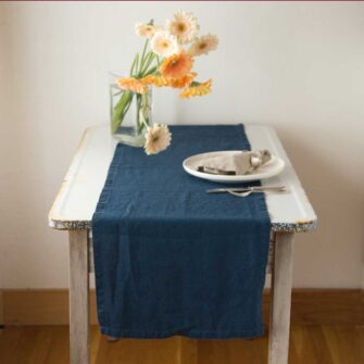 Swans Island Company's linen table runner by Linen Tales, made with 100% European Linen Oeko-Tex® and EUROPEN FLAX® certified. Made with stonewashed soft linen with mitered corners for a crisp edge. Shown here in Navy Blue color.