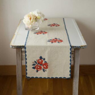 Swans Island Kamala Table Runner by Soil to Studio. Block printed by hand in India with bright playful patterns. Shown here in Natural Tan check with Red Roses.