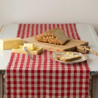 Swans Island Company's linen table runner by Linen Tales, made with 100% European Linen Oeko-Tex® and EUROPEN FLAX® certified. Made with stonewashed soft linen with mitered corners for a crisp edge. Shown here in Red and Natural Flax Gingham Check.