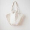 Swans Island Company's Anya Embroidered Tote bag by Govou. Upcycled antique grain sacks are reimagined into unique tote bags. This one features hand-stitched seashore embroidery motifs. Shown here in natural colorway.