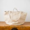 Swans Island Company's Embroidered Quilt Basket Bag by Govou. Upcycled antique grain sacks are reimagined into unique tote bags. This one features a hand-stitched nautilus shell embroidery motif. Shown here in natural colorway.