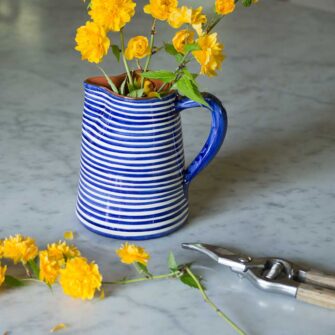 Swans Island Company's Striped Terracotta Pitcher - Handmade in Portugal. Shown here in Blue and white.