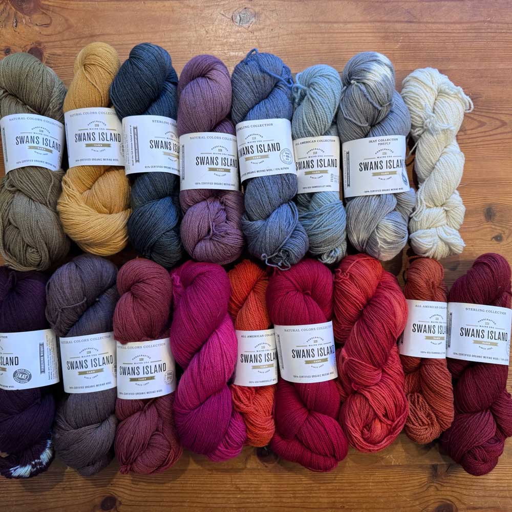 Swans Island Company's 2025 Limited Edition "Autumn in New England" Throw commemorates Yankee Magazines' 90th anniversary. This handwoven throw features 90 color changes in vibrant autumn hues of hand-dyed color. Made in Maine. Closeup detail of skeins of hand-dyed Swans Island hand-dyed yarns used in this throw.