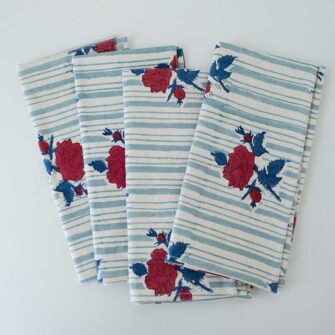 Swans Island Company's Supriya napkins by Soil to Studio. Block printed by hand in India with bright playful patterns. Shown here in natural with aqua vine and red/teal rose pattern.