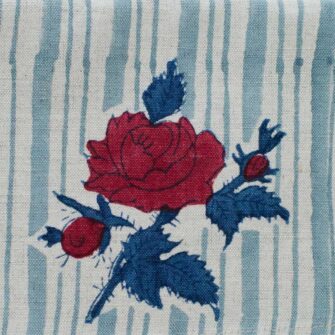 Swans Island Company's Supriya napkins by Soil to Studio. Block printed by hand in India with bright playful patterns. Shown here in natural with aqua vine and red/teal rose pattern.