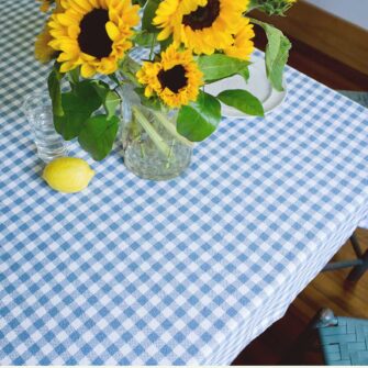 Swans Island Company's Gingham Check tablecloth. Woven in Maine. Shown here in Wedgwood & White.