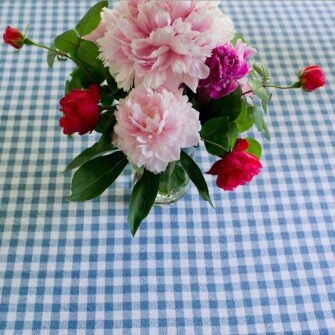 Swans Island Company's Gingham Check tablecloth. Woven in Maine. Shown here in Wedgwood & White.
