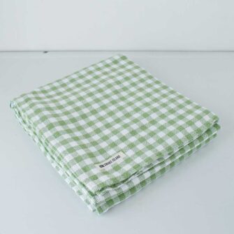 Swans Island Company's Gingham Check tablecloth. Woven in Maine. Shown here in Sage & White.