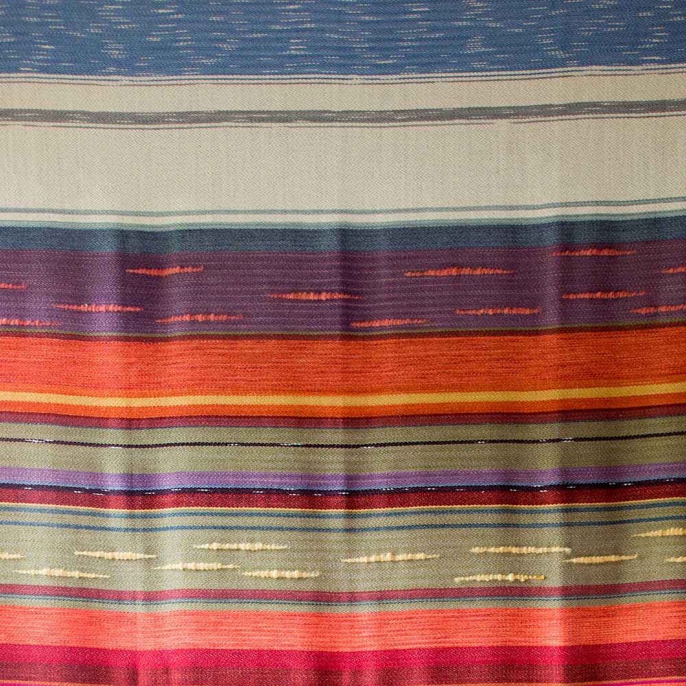 Swans Island Company's 2025 Limited Edition "Autumn in New England" Throw commemorates Yankee Magazines' 90th anniversary. This handwoven throw features 90 color changes in vibrant autumn hues of hand-dyed color. Made in Maine. Limited supply. Closeup Detail of a portion of the throw.