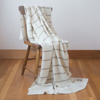 Casa Branca x Swans Island - Branca Ticking Stripe Throw . 100% soft merino wool with hand-dyed stripes and ivory silk binding. Handwoven in Maine. Shown here in Biscotti.